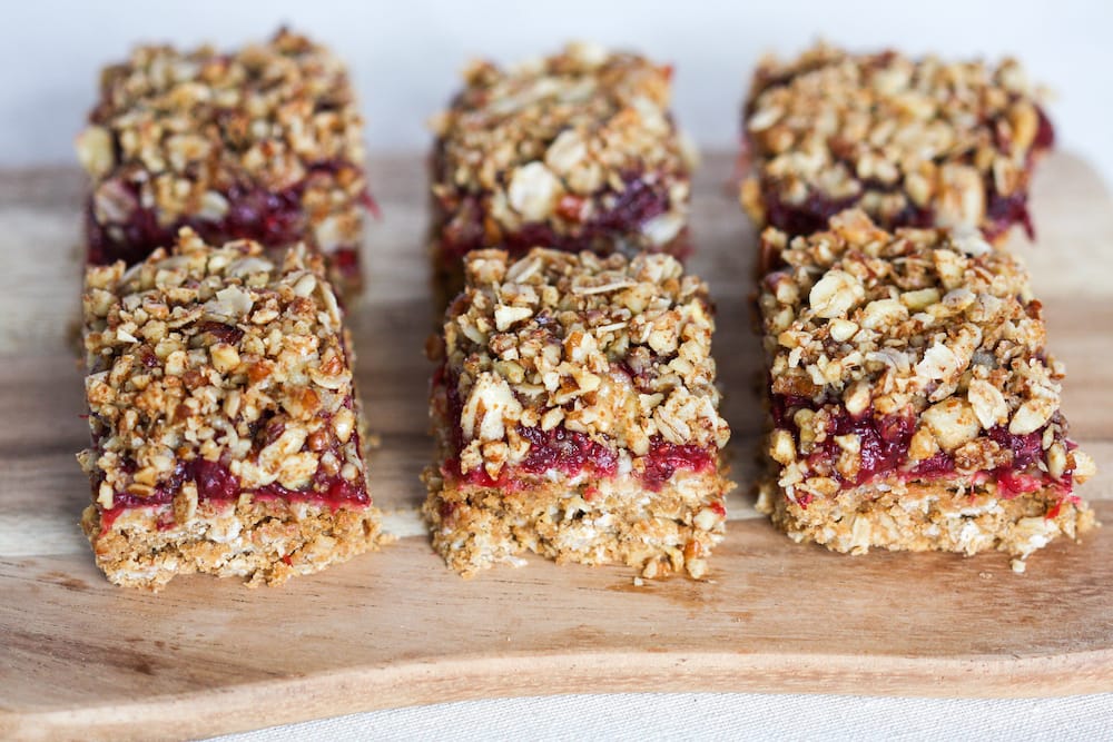 Gaia Tree's plum crumble squares close up on a wooden board