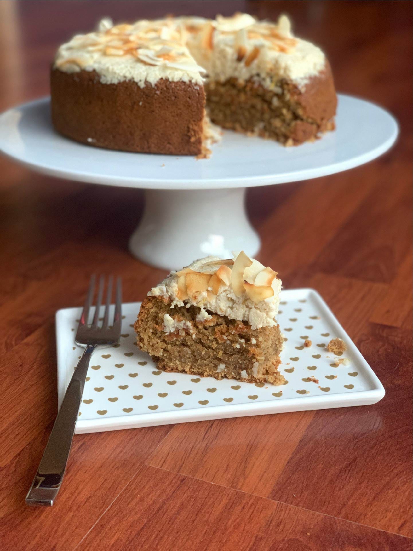 Gaia Tree's dairy-free lemon coconut cake with cut slice ready to serve