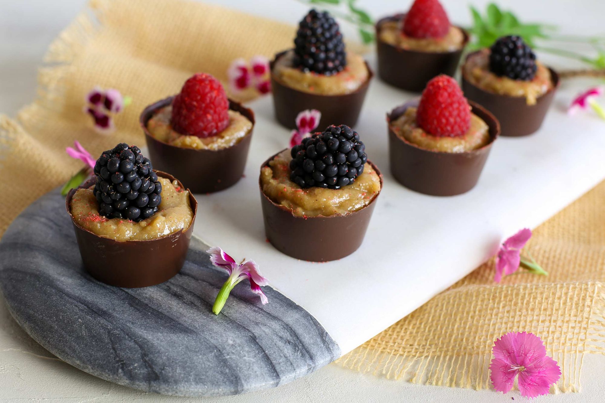 Platter of chocolate cashew cream cups with berries